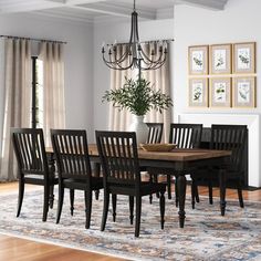 a dining room table and chairs with a rug on the floor