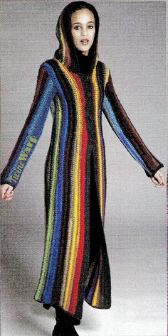 a woman wearing a multicolored knitted coat