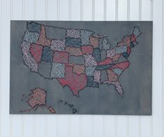 a map of the united states made out of string art on a gray wall with white paneling