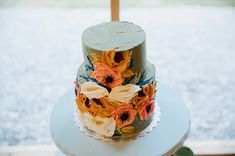 a three tiered cake with flowers on it