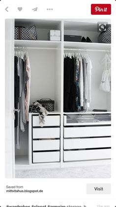 a white closet with drawers and clothes hanging on the shelves, all in black and white