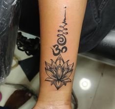 a woman's arm with a lotus tattoo on it