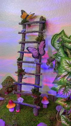 a small wooden ladder sitting on top of a moss covered ground next to a potted plant