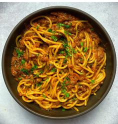 a bowl filled with spaghetti and meat sauce