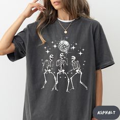 Get into the spooky spirit with our Halloween shirt! Featuring a fun, festive design perfect for trick-or-treating or Halloween parties. This comfy, short-sleeve tee is a must-have for adding a touch of eerie style to your wardrobe. Great for pairing with costumes or everyday wear during the spooky season! ---------------------------------------------- I N F O R M A T I O N ---------------------------------------------- Our shirts are made to order specially for you. Because of this reason we don't accept returns or exchanges. Please check our color and size charts before you place your order. If you have any questions please send us a message to clarify sizing or colors. - Please contact us via message box if you like to add or change anything on the design that's shown on the pictures to Skeleton Disco Shirt, Cute Fall Tshirt Designs, Ball Dancing, Trendy Crewneck, Graphic Print Top, Dancing Skeleton, Types Of T Shirts, Skeleton Shirt, Fall Tee