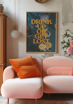 a pink couch sitting in front of a clock on the wall next to a vase with flowers