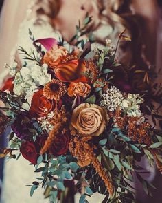 a bride holding a bouquet of flowers in her hands