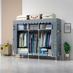 a large gray cabinet with clothes hanging on it's sides and shelves in the middle