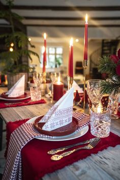 a table set for christmas with candles and napkins