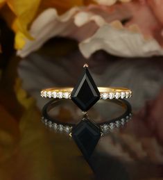 a black diamond ring sitting on top of a table