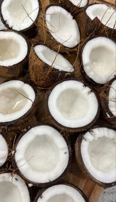 coconuts are cut in half on a cutting board