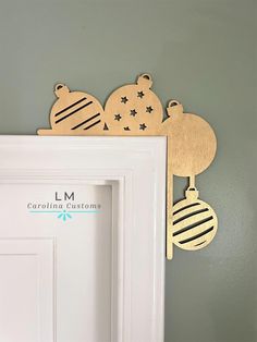 wooden ornaments hang on the wall above a door