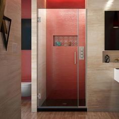 a bathroom with a glass shower door and wooden flooring, along with a white sink