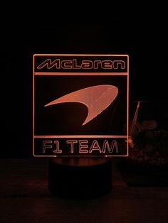 a neon sign that reads meldron team on it's side in the dark