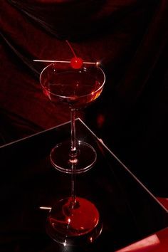 a red drink sitting on top of a black table