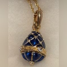 From The World Renowned Romanov Gifts Co, We Bring You The Last Available Stock Of The Iconic Brand. Imperial Empress Egg Necklace, In Beautiful Cobalt Blue. The Necklace Is Cast Of Bronze, With 22k Yellow Gold-Plated Accents. Set With Austrian Crystal Gemstones, This Pendant Features A Translucent Enameling Of Royal Blue. The Chain Is 18 Inches In Length. The Egg Pendant Measures Approximately 1 In. Height. The Chain Has An Authentic Hallmark “Faberge” Tag, With The Initials “I.F.” Engraved On Faberge Necklace, Egg Necklace, Russian Jewelry, Faberge Jewelry, The Egg, Austrian Crystal, Crystals And Gemstones, Cobalt Blue, Blue Gold