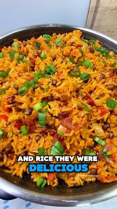 a large metal pan filled with rice and veggies