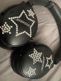 two black headphones with white stars on them