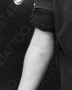 a person with a small tattoo on their arm and the word love is written in black ink