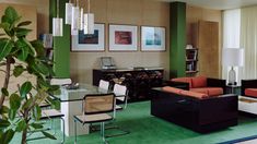 a living room filled with lots of furniture and decor on top of a green floor