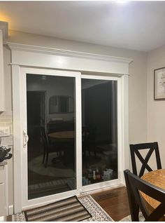 an empty dining room with sliding glass doors