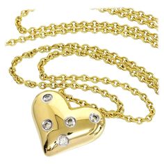 TIFFANY & Co. Etoile 18K Gold 5 Diamond Heart Pendant Necklace Metal: 18K yellow Gold Weight: 9.30 grams Chain: 16" Pendant: 16mm wide Diamond: 5 round brilliant diamonds, carat total weight .15 Hallmark: "©TIFFANY&CO. 750 PT950" on pendant, "TIFFANY&CO. 750" on chain tag Condition: Like new, comes with Tiffany pouch, box and ribbon bow Authenticity Guaranteed Diamond Heart Pendant Necklace, Heart Pendant Diamond, Tiffany And Co, Metal Necklaces, Diamond Heart, Heart Pendant Necklace, Ribbon Bows, Tiffany & Co., Heart Pendant