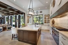 a large kitchen with an island in the middle and lots of counter space on each side