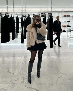 a woman in a fur coat talking on a cell phone