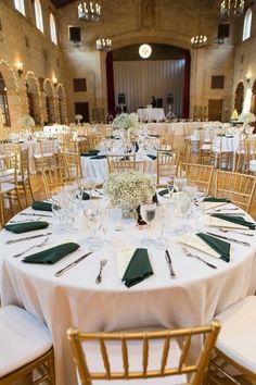 the tables are set with white and green linens