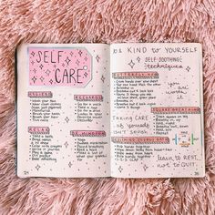 an open notebook with writing on it sitting on top of a pink blanket next to a cup of coffee