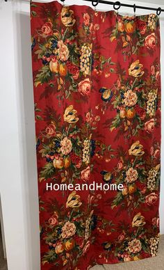 a red shower curtain with flowers on it and the words home andhome written in white