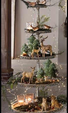 three tiered trays with christmas decorations and deer figurines on each shelf