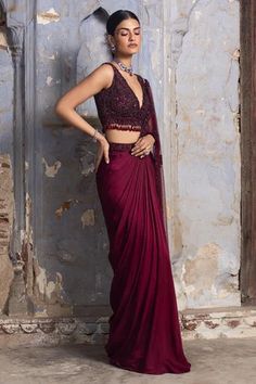 Burgundy satin and net draped saree with embroidered pallu. Paired with a net blouse in tonal bead work, sequins and crystals.
Components: 2
Pattern: Embroidered
Type Of Work: Bead,Crystals
Neckline: Plunge V
Sleeve Type: Sleeveless
Fabric: Saree: Satin, Blouse: Net
Color: Maroon
Other Details: 
Back tassel tie-up
Embroidered blouse
Occasion: Cocktail,Reception - Aza Fashions Drape Sari, Maroon Saree, Net Blouse, Draped Saree, Net Blouses, Bridal Lehenga Red, Drape Saree, Indian Wedding Wear, Ready To Wear Saree