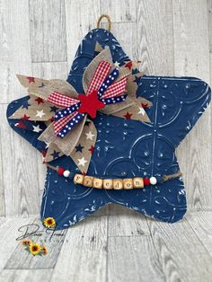 a wooden star decoration with red, white and blue stars on it's side