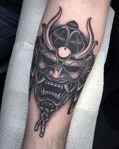 a man with a tattoo on his arm wearing a mask