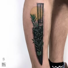 a man with a tattoo on his leg has a knife and plants in the background