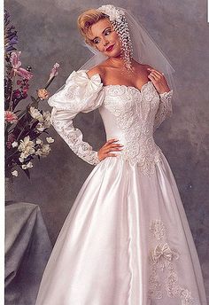 a woman in a wedding dress posing for the camera