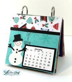 a calendar with a snowman on it and a christmas card attached to the front