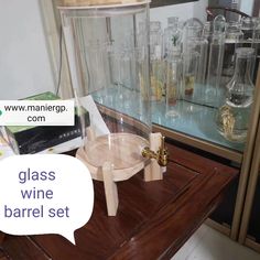 a glass wine barrel set on top of a table with a speech bubble above it