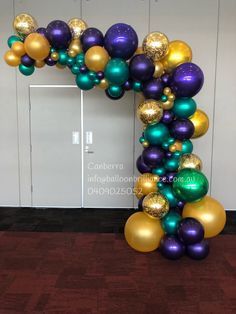 an arch made out of balloons in the shape of a number one with gold, purple and green colors