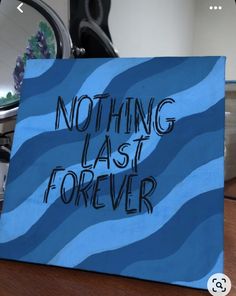 there is a sign that says nothing last forever on the table in front of a mirror