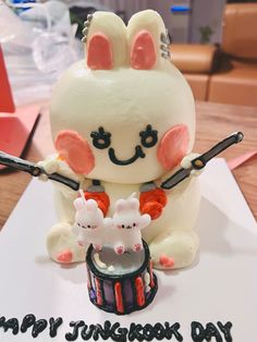 a birthday cake with an image of a bunny holding a drum and playing the drums