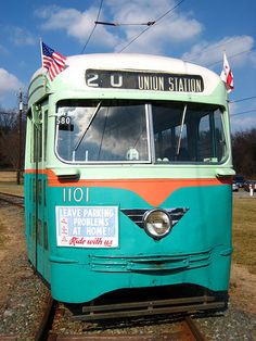 an old bus is sitting on the tracks