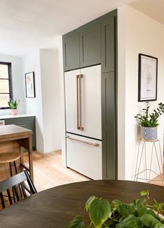 a kitchen with a table, chairs and an oven in the middle of the room