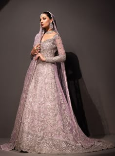 a woman in a purple gown and veil