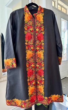 Discover the epitome of elegance with our Traditional Kashmiri Designer Jacket. Impeccably crafted with fine heavy embroidery on both the front and back, this versatile silk coat exudes sophistication. Featuring a classic button-up style and fully lined interior, it offers both sophistication and comfort. Complete with two side pockets, it seamlessly blends traditional craftsmanship with modern functionality. Elevate your wardrobe with this exquisite piece, a testament to quality and refinement. Fall Multicolor Embroidered Nehru Jacket, Fall Embroidered Kurta, Nehru Jacket With Multicolor Resham Embroidery For Fall, Traditional Nehru Jacket With Floral Embroidery For Fall, Fall Nehru Jacket With Multicolor Resham Embroidery, Multicolor Resham Embroidered Nehru Jacket For Fall, Traditional Outerwear With Embroidered Border For Fall, Traditional Embroidered Border Outerwear For Fall, Floral Embroidered Outerwear For Eid