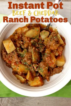 slow cooker beef and cheddar ranch potatoes in a white bowl with a spoon