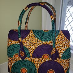 Gorgeous Orange, Purple, And Turquoise Mandala Style Wax Print. Bag Is Large Enough To Fit A Small Macbook With Room For A Wallet, Water Bottle And A Few Papers. Purple Square Box Bag For Shopping, Purple Bags With Adjustable Handle For Daily Use, Purple Bag With Adjustable Handle For Daily Use, Daily Use Purple Bag With Adjustable Handle, Purple Handheld Travel Bag, Purple Rectangular Bags With Adjustable Handle, Purple Travel Bag With Adjustable Handle, Purple Shoulder Box Bag For Shopping, Purple Rectangular Bag With Top Carry Handle