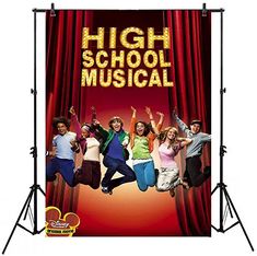 the poster for high school musical is hanging on a wall in front of a red curtain