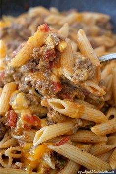 a spoon full of pasta with meat and cheese